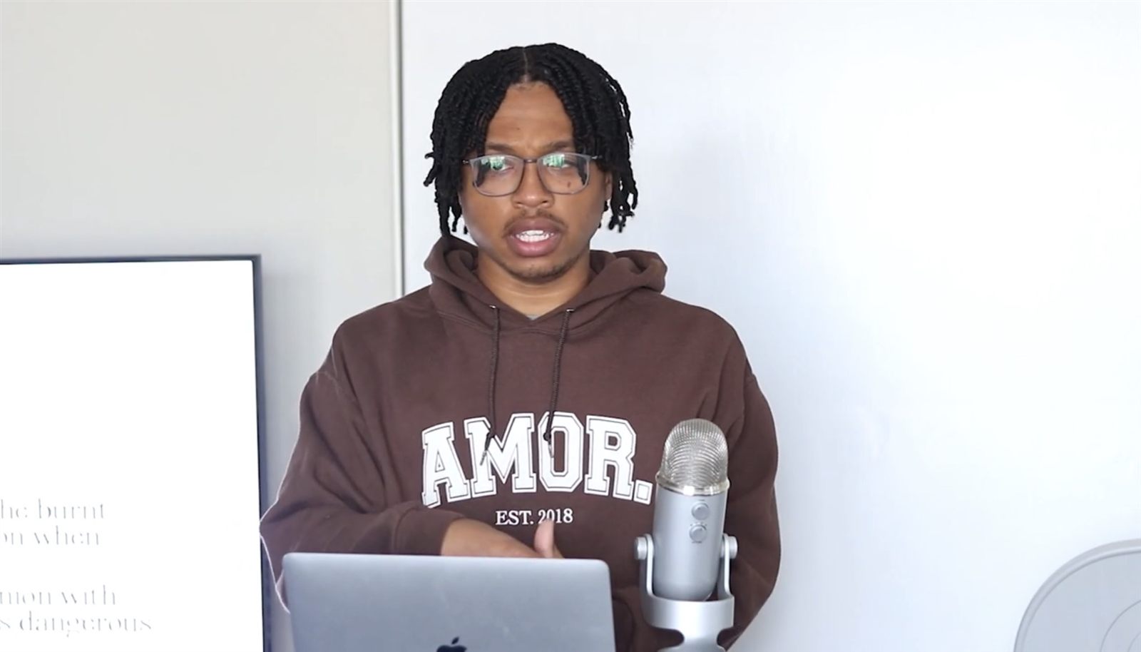 Elijah teaching from his desk
